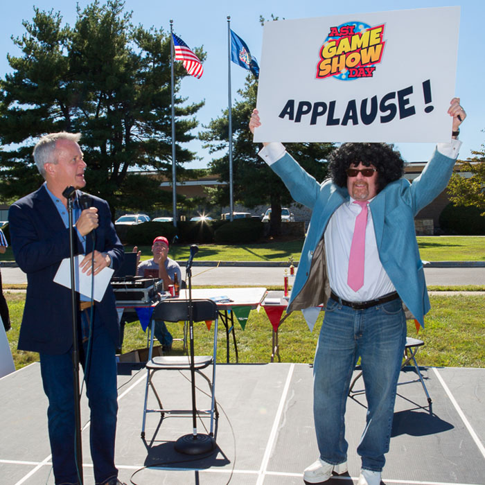 Tim Andrews, Joe Haley holding up applause sign
