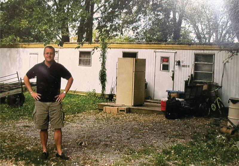 Tim Andrews in front of trailer home